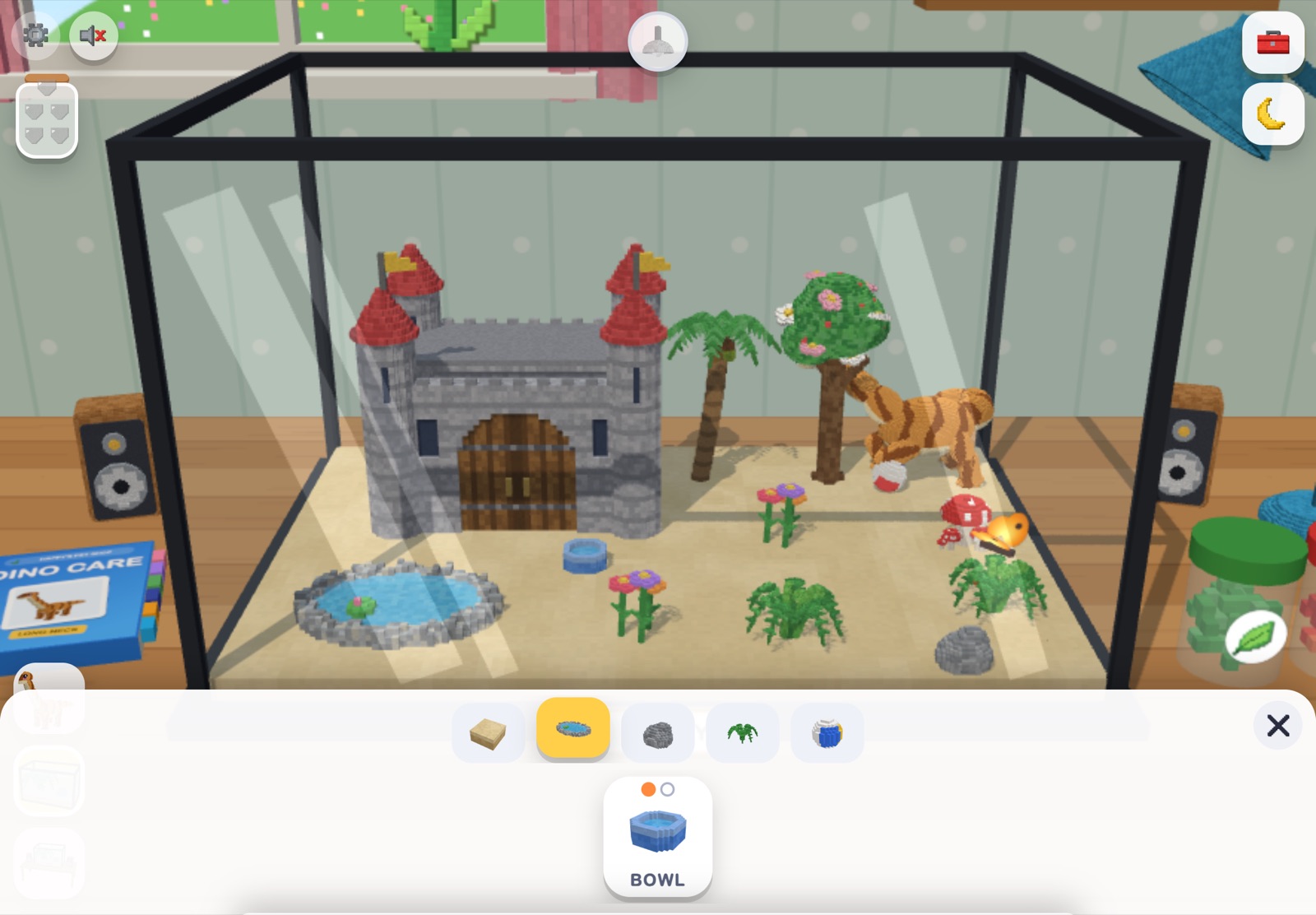 The decorating tray open at the bottom of the screen, with ground, water, rocks and plants to choose from